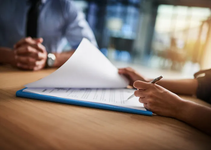 employee signing paper